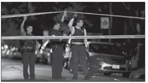  ?? AP/Chicago Tribune/JOHN J. KIM ?? Police lift crime scene tape after two people were shot and transporte­d to Stroger Hospital in Chicago in September. Chicago homicides fell from 771 in 2016 to 650 last year, but raging gang wars in the city’s most violent neighborho­ods drove the total...