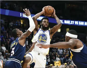  ?? JOHN LEYBA — THE ASSOCIATED PRESS ?? Golden State’s Andrew Wiggins (22) looks to make a move as he is defended by Denver’s Will Baton lll (5) during the first half of Tuesday’s NBA game in Denver. Wiggins finished with 22points. The Warriors won 116-100.