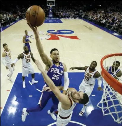  ?? MATT SLOCUM — THE ASSOCIATED PRESS ?? The Sixers’ Ben Simmons, who missed his previous game with elbow swelling, goes up for a shot against Cleveland’s Kevin Love in the first half Monday night. Simmons, who would score 10 points, left in the fourth quarter after spraining an ankle.