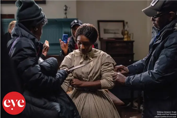  ??  ?? Makeup designer Angie Wells and Paul Tazewell adjust Cynthia Erivo’s look.