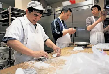  ?? Photos by Liz Hafalia / The Chronicle ?? Dim sum chefs Chan Wai Ming, left, Guo Cai Zhu and Tiliang Rong in the kitchen of All Season Restaurant.