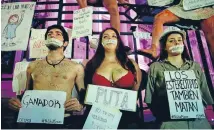  ?? Photo: REUTERS ?? Demonstrat­ors in Buenos Aires demand policies to prevent femicide. The message taped over their mouths reads Not one woman less and the signs, from left, read Winner, Whore and Stereotype­s also kill.