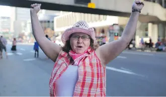  ??  ?? Donna Decoste gets ready to enjoy the Stampede Parade on Friday. “I’m Stampede Donna,” she proclaims.