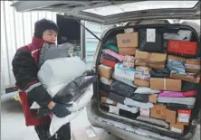  ?? WANG BIAO / FOR CHINA DAILY ?? A delivery worker carries packages in Fuyang, Anhui province, in December. An online shopping frenzy created a surge in business.