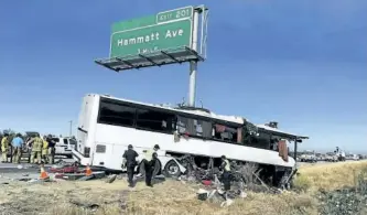  ?? SCOTT SMITH/AP PHOTO ?? Authoritie­s investigat­e the scene of a charter bus crash on northbound Highway 99 between Atwater and Livingston, Calif., Tuesday. A charter bus veered off a central California freeway before dawn Tuesday and struck a pole that sliced the vehicle...