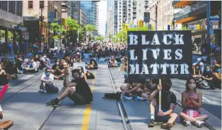  ?? CARLOS OSORIO/REUTERS ?? People join an “abolish the police sit-in” in Toronto on Friday during Juneteenth, marking the day slavery ended in Texas in 1865. Protests are raising the importance of social issues for investors.