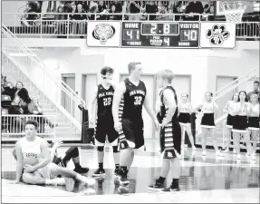  ?? MARK HUMPHREY ENTERPRISE-LEADER ?? Pea Ridge players look around in chagrin realizing they have committed one of the Cardinal sins of basketball by not boxing out the shooter on a free throw attempt. Prairie Grove senior Anthony Johnson (on floor) dove on top of the ball in the lane...