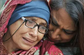  ?? Vincent Thian/Associated Press ?? A woman who lost her husband during Friday’s mass shootings cries outside an informatio­n center for families Saturday in Christchur­ch, New Zealand.