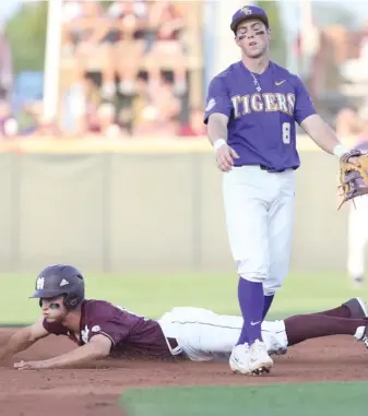  ?? (Photo by Kelly Price, MSU athletic media relations, for Starkville Daily News) ?? Mississipp­i State's Jake Mangum slides safely into second base much to the dismay of LSU infielder Cole Freeman (8) during the final regular season series in Starkville.
