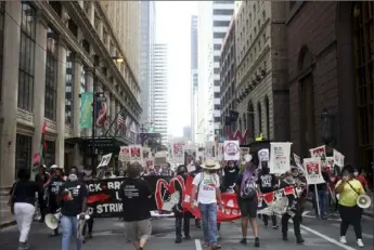  ?? Joshua Housing/Associated Press ?? People march from a McDonald's restaurant on 180 W. Adams St. back to the James R. Thompson Center in Chicago on Monday as a part of a nationwide strike.