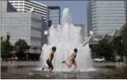  ?? DON RYAN — THE ASSOCIATED PRESS ?? Langstrom Kalstrom, left, and Violet Dashney run through the Salmon Street Springs fountain in Portland, Ore., Thursday.