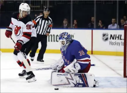  ?? ADAM HUNGER - THE ASSOCIATED PRESS ?? New York Rangers goaltender Henrik Lundqvist makes a save in front of New Jersey Devils’ Marcus Johansson (90) in the first period of a preseason NHL hockey game, on Monday, Sept. 24, 2018, in New York.