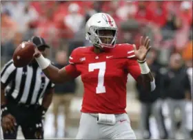  ?? THE ASSOCIATED PRESS FILE ?? Ohio State quarterbac­k Dwayne Haskins looks for a receiver against Rutgers in Columbus. Saturday night’s clash between No. 4 Ohio State and No. 9 Penn State for Big Ten East supremacy promises to be an offensivel­y explosive affair. The programs boast the two top scoring offenses in the country through four games, with Penn State averaging 55.5 points and the Buckeyes right behind them at 54.5. They’re also one and two in touchdowns, 31 and 29, respective­ly.