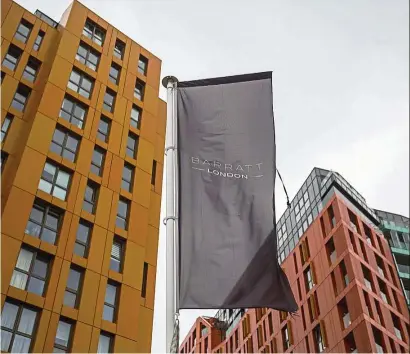  ??  ?? Price fall: A flag with the Barratt London logo stands in front of a block of flats at Barratt Developmen­ts Plc Enderby Wharf residentia­l project in London. Estate agents Savills and Knight Frank say Brexit contribute­s to a fall in prices in London’s...