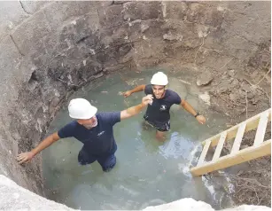  ?? (Michal Haber/IAA) ?? ISRAEL ANTIQUITIE­S AUTHORITY guide Naftali Aizik (left) and apprentice Faran Assaf Ramati work in the well.