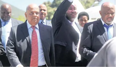  ?? PICTURE: DAVID RITCHIE ?? BALANCING ACT: Finance Minister Pravin Gordhan came out to accept the memorandum from the students before giving his mid-term budget speech in the National Assembly yesterday. Students and police later clashed in the afternoon as police used stun...