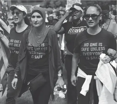  ?? ALEX WONG / GETTY IMAGES FILES ?? Activist Linda Sarsour, centre, and fellow gun-control activists participat­e in a march beginning at the headquarte­rs of National Rifle Associatio­n July 14 in Fairfax, Va.