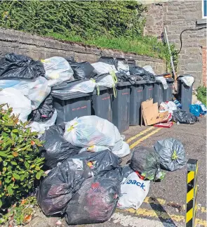  ??  ?? Piles of rubbish in Seabraes Lane in the West End.