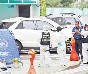  ??  ?? Police inspectors stand next to a tent set up at the spot where Roh was found dead near the gate of an apartment building in central Seoul. — AFP photo