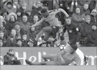  ?? The Associated Press ?? Wolverhamp­ton Wanderers’ Nouha Dicko jumps as he vies for the ball against Liverpool’s Joe Gomez during the English FA Cup, fourth-round soccer match Saturday in Liverpool, England.