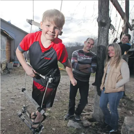  ?? JEAN LEVAC ?? Caleb Fournel, left, Martin, Susie and sister Rebecca, right, at their family farm in Edelweiss, Que., in April. Susie and Martin Fournel’s son, Caleb, has a rare condition known as PANDAS. Caused by a strep infection, it suddenly sparks OCD and other...