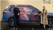  ?? ?? Fair Director Jaya Asokan (Right) and Prof. Thomas Girst, Global Head of Cultural Engagement at the BMW Group posing with a customized version of BMW X7 with design by Bengaluru based artist Devika Sundar.