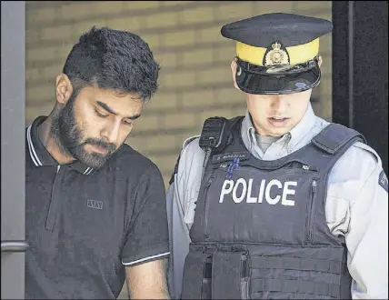  ?? KAYLE NEIS/THE CANADIAN PRESS ?? Truck driver Jaskirat Sidhu is seen walking out of provincial court after appearing for charges stemming from the Humboldt Broncos bus crash in Melfort, Sask. Sidhu is charged with 16 counts of dangerous driving causing death and 13 more of dangerous driving causing bodily harm. The case has been adjourned until the new year.