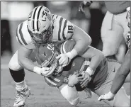  ?? LSU defensive end AP/ROGELIO V. SOLIS ?? Christian LaCouture (18) tackles Mississipp­i quarterbac­k Shea Patterson in the first half Saturday in Oxford, Miss. Patterson will miss the rest of the season after an MRI Sunday revealed a torn posterior ligament in his right knee.