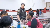  ?? AUDRA MELTON/NEW YORK TIMES ?? Pamela Revels, a school resource officer, greets elementary school students March 1 in Loachapoka, Ala. A federal report released Thursday promoted the formation of ‘threat assessment teams’ to help identify and support troubled youths.