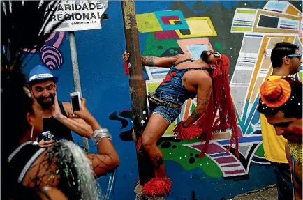  ?? PHOTO: REUTERS ?? Revellers take part in an annual block party known as ‘‘Ceu na Terra’’ (Heaven on Earth), one of the many carnival parties to take place in the neighbourh­oods of Rio de Janeiro.