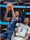  ?? Greg Fiume/Getty Images ?? UConn’s Tristen Newton (2) drives to the basket against Georgetown’s Brandon Murray on Saturday.