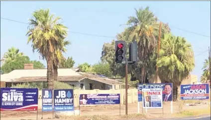  ?? PHOTO MICHAEL MARESH ?? Intersecti­ons have long been popular locations for political signage during election season, but such displays on public property in El Centro are no longer legal and the city is telling candidates to remove their signs or face consequenc­es.