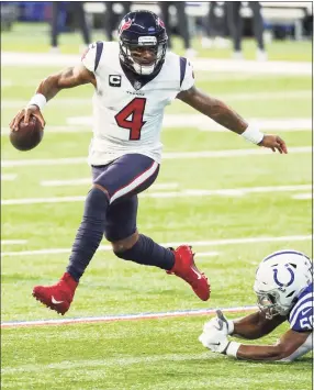  ?? Brett Coomer / Houston Chronicle ?? Texans quarterbac­k Deshaun Watson leaps out of the grasp of Colts defensive end Justin Houston during a December game.