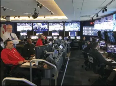  ?? BRIAN MAHONEY — THE ASSOCIATED PRESS ?? Joe Borgia, standing left, NBA senior vice president of replay and referee operations, talks to senior replay manager Monte Shubik at the National Basketball Associatio­n Replay Center in Secacus N.J.