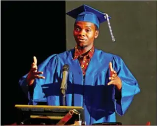  ??  ?? DCLC student Mussa Kromah of Sharon Hill gives his commenceme­nt speech at a combined GED graduation ceremony.
