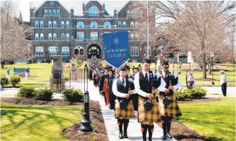  ?? MORNING CALLFILE PHOTO ?? A procession moves across the campus at Moravian College as part of the inaugurati­on ceremony of the school’s 16th president, Bryon Grigsby, in July 2013. Grigsby announced this week the college is transition­ing to a university.