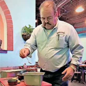  ?? [PHOTOS BY DAVE CATHEY, THE OKLAHOMAN] ?? Marcelino Garcia makes salsa at the Moore location of his Chelino’s Mexican Restaurant chain.