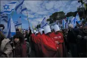  ?? OHAD ZWIGENBERG — THE ASSOCIATED PRESS ?? Israelis protest against plans by Prime Minister Benjamin Netanyahu’s new government to overhaul the judicial system, Israel’s parliament, in Jerusalem on Monday.