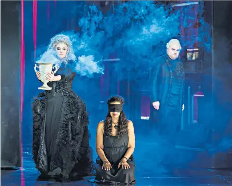  ??  ?? Blackly farcical: from left, Sara Fulgoni as Ulrica, Mary Elizabeth Williams as Amelia and Roland Wood as Renato in WNO’S Un ballo in maschera
