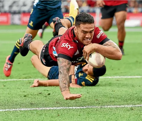  ?? PHOTOSPORT ?? Codie Taylor dives over for an early try during his standout performanc­e for the Crusaders in their win over the Highlander­s.