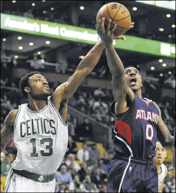  ?? JESSICA HILL / ASSOCIATED PRESS ?? Hawks point guard Jeff Teague attempts to shoot before the Celtics’ James Young can get in the way. Teague finished with 10 points and eight assists.