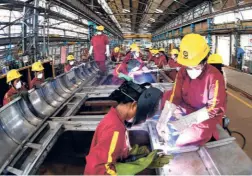  ??  ?? THE ALL-WOMEN team engaged in manufactur­ing the side wall of a coach at the Integral Coach Factory in Chennai.
