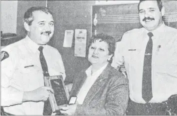  ?? FILE ?? Windsor RCMP Cst. Mac McIver received an engraved plaque and silver pin in 1993 from the Nova Scotia Block Parents Associatio­n for exceptiona­l service. Pictured making the presentati­on were Joan Barnhill, the chairwoman of Block Parents, and Cst. Garry Hicks, the vice-chair of the organizati­on.