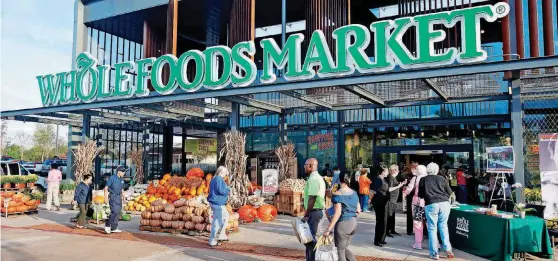  ?? [OKLAHOMAN ARCHIVES PHOTO] ?? Shoppers are seen at the entrance to Whole Foods Market that opened in Oklahoma City in 2011.