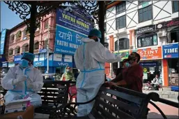  ?? TAUSEEF MUSTAFA/AFP VIA GETTY IMAGES ?? A medical worker collects a swab sample from a man for a rapid antigen test for COVID-19 in Srinagar, India on Thursday.