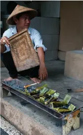  ??  ?? On the streets … (from left) a basket filled with offerings; a seller at Ubud market; a Balinese artisan sculpting a stone statue; chicken sate and fish being cooked in banana leaves on a charcoal grill.