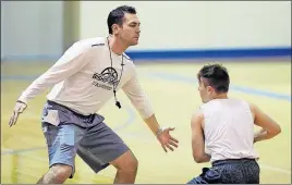  ?? [KYLE ROBERTSON/DISPATCH] ?? Dan DeCrane, in his fourth year as Ready’s coach, plays defense during a practice last week.