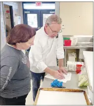  ?? (Special to NWA Democrat-Gazette/Maylon T. Rice) ?? Jenn Clampitt (left), a registered dietitian with University of Arkansas for Medical Sciences, works with consulting chef Kent Getzin on the ingredient­s needed for future meals at Lincoln Middle School.