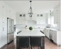  ??  ?? This renovation project by Amsted Design-Build is a winner in the OHBA 2016 Awards of Distinctio­n in the category of Most Outstandin­g Home Renovation up to 250,000 sq. ft. A dark elongated island anchors the airy white kitchen, which is accented with...