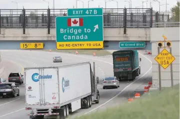  ?? — Reuters ?? Commercial trucks exit the highway for the Bridge to Canada, in Detroit, Michigan US.